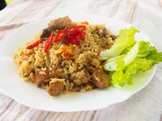 plate with pilaf, hot pepper and herbs. national cuisine. Oriental food.
