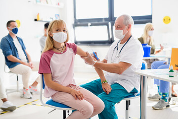 Obraz premium Child with face mask getting vaccinated, coronavirus, covid-19 and vaccination concept.