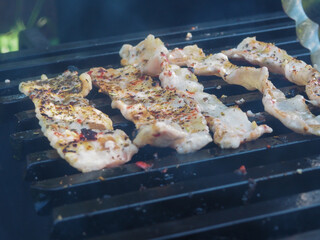 frying bacon on the grill. spiced bacon with a Golden crust. cooking food at the picnic