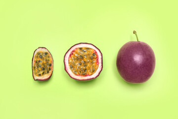 Fresh ripe passion fruits (maracuyas) on light green background, flat lay