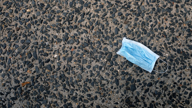Blue Disposable Fask Mask Discarded on Ground