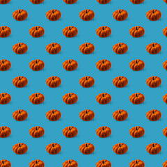 Pattern with orange pumpkins on blue background