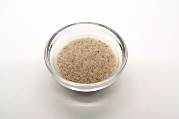 psyllium seeds in a transparent bowl, detailed view in a photo box