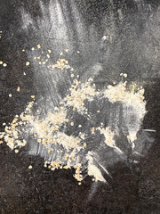 Flour and oatmeal on a dark textured background. View from above