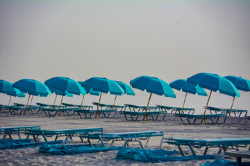 Umbrellas positioned perfectly in the sand in a bright sunny day at Miami Beach