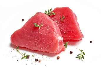 Two slice of raw tuna meat with thyme herbs and spices isolated on white background.