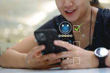 Customer service evaluation concept. young smart asian female pressing face emoticon on virtual...