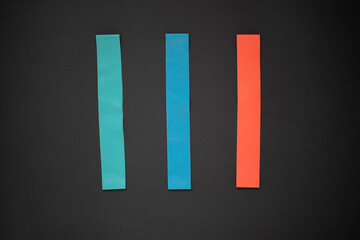 Multi-colored elastic rubber bands for fitness on a white wooden background. A set of rubber bands of different colors - red, blue and turquoise. Ideal for training at home.