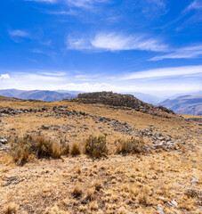 sunny day walking through the mountains of peru seeing curious rock formations