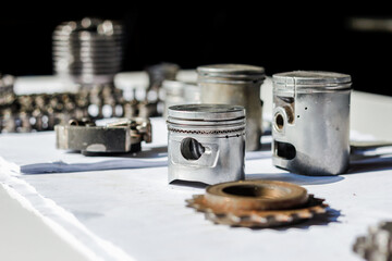 Motorcycle spare parts are placed on a white table to study and design a shape for higher...