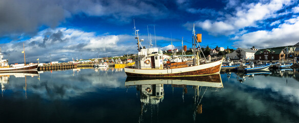 A boat at the harbor of Husavik, ready to go with its passengers on a whale watching tour. Photo...