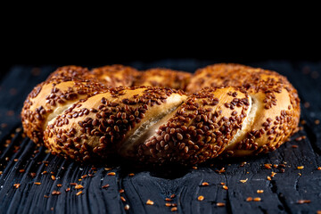 Bagel with sesame on black background