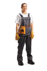 Full length portrait of a repairwoman with a tool belt in a gray uniform