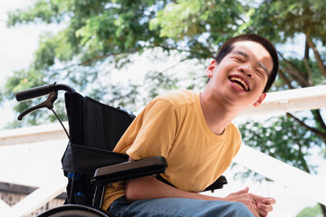 Disabled child on wheelchair is playing,learning and exercise in the outdoor horse farm,Nature background,Lifestyle of special child,Life in the education age of children,Happy disability kid concept.