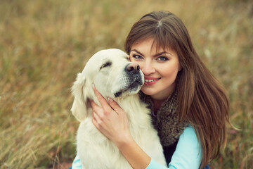 golden retriever for a walk with his owner. Dog breed labrador with woman outdoors