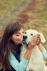 golden retriever for a walk with his owner. Dog breed labrador with woman outdoors