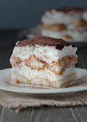 Delicious traditional tiramisu cake on a plate.