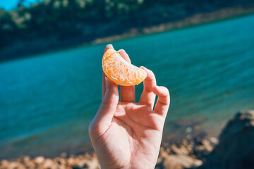 Person holding a juicy peeled tangerine