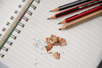 Notebook and pencil with pencil shavings,