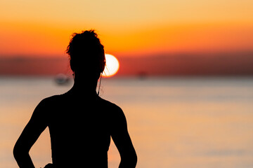 silhouette of a girl on a sunset background