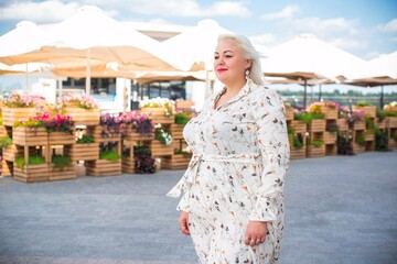 Plus size woman, American or European appearance walks in the city enjoying life. A young lady with...