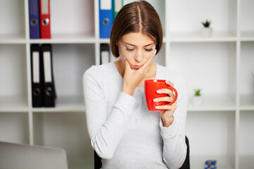 Beautiful young woman suffering from terrible severe toothache, touching cheek with hand.