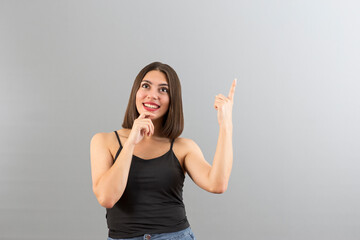 Beautiful Turkish woman in puzzled mood, isolated studio shot with copy space