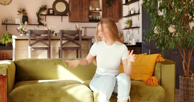 Young woman angrily texting into messages uses a mobile phone, gets angry and throws out the phone annoyed and turned away get the hump.