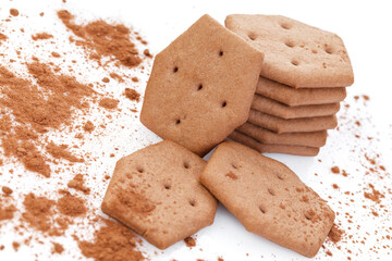 Sweet crackers with cocoa isolated on white background. Cracker sprinkled with cocoa. Close-up. There is free space for your text or sign.