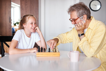 smart grandfather teach granddaughter to play chess, family relationship with granddad and...