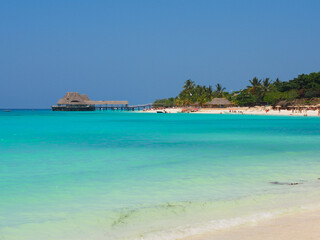 Sunny beach day, white sand, blue Indian ocean in Zanzibar island, Tanzania. Copy space for text.