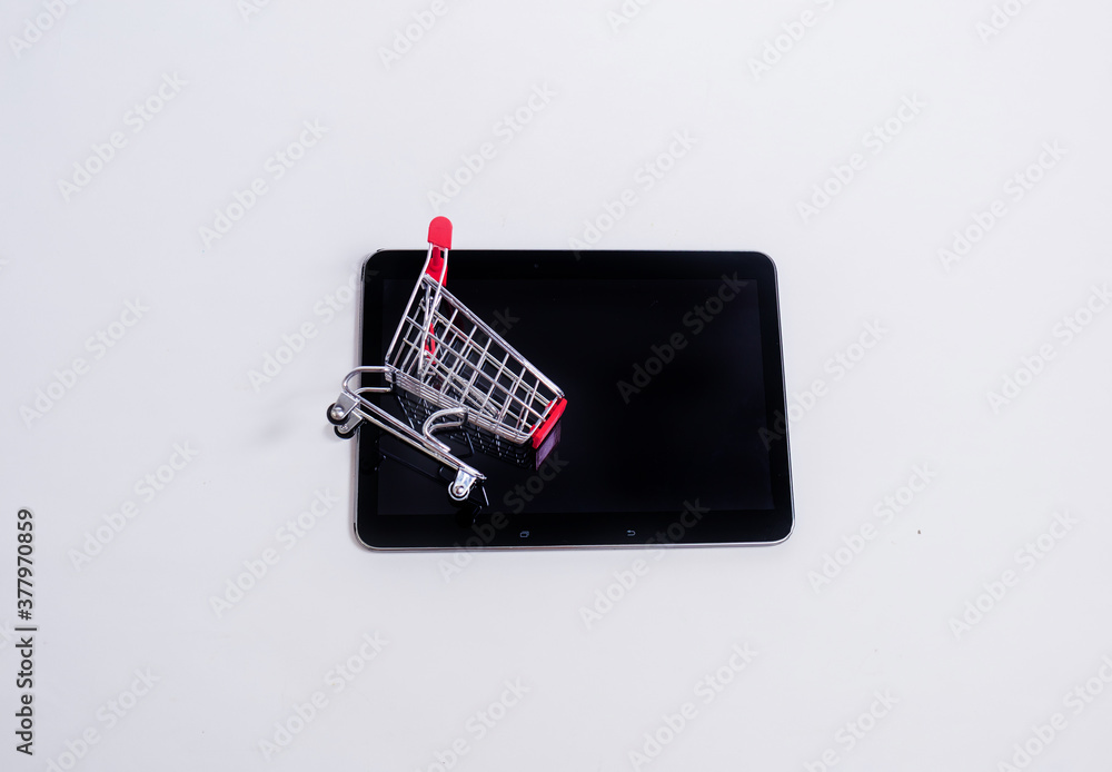 Wall mural black tablet with a metal basket on a white background with space for text