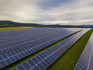 Field of solar panels for energy production, environmental energy on a green background