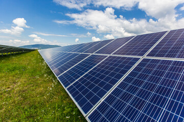 Field of solar panels for energy production, environmental energy on a green background