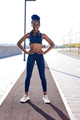 portrait of slim african female ready to running, workout. stand posing, wearing sportswear