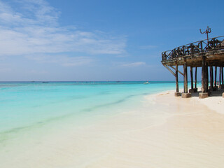 Sunny beach day, white sand, blue Indian ocean in Zanzibar island, Tanzania. Copy space for text.