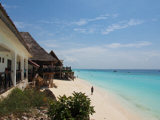 Sunny beach day, white sand, blue Indian ocean in Zanzibar island, Tanzania. Copy space for text.