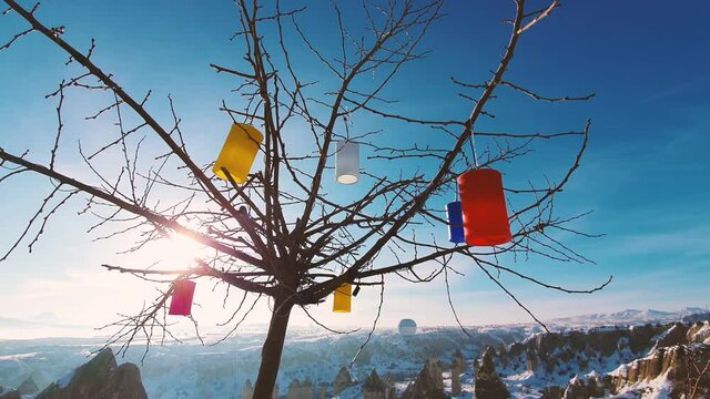 View of the mountains and the tree decorated with colored lanterns.