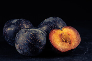 Purple plum on black background
