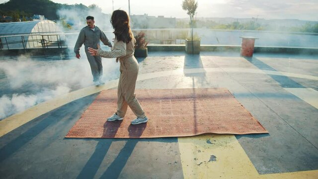 Hip hop culture. Modern youth. Stunning active young woman doing hip hop choreography moves enjoying dance battle with handsome man. Break dancers. Couple. Entertainment.