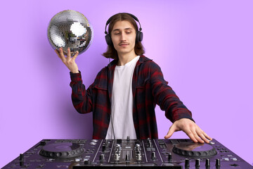 DJ disco icon perform music, holding disco ball in hands. modern stylish guy in headphone enjoy...