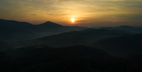 mountains landscape with sun and alpine pines. Sunrise