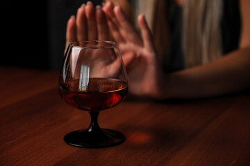 Young woman alcoholic social problems concept sitting refusal of alcohol
