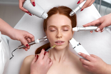 several beauticians holding their equipment near female face, beauty and cosmetology concept. mesotherapy cosmetic procedures