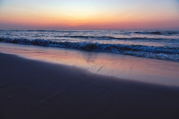 Sunset at North Sea Kijkduin Beach in the Netherlands where the land, sea and sky meet
