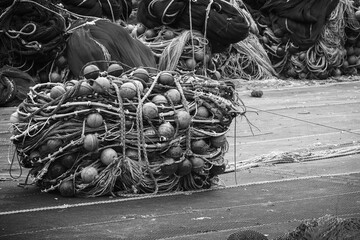 Drying fishing net lays on the sea coast in port
