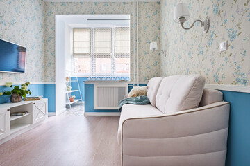 Compact room in vintage style with white sofa, wardrobe, TV area