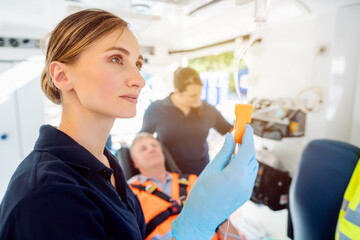 Paramedic looking after the drop injection in an ambulance