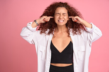 Disturbed timid cute redhead curly woman hate hear someone shouting, squinting, close eyes and...