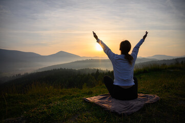 Silhouette of a girl in the mountain sun sky. Sunrise